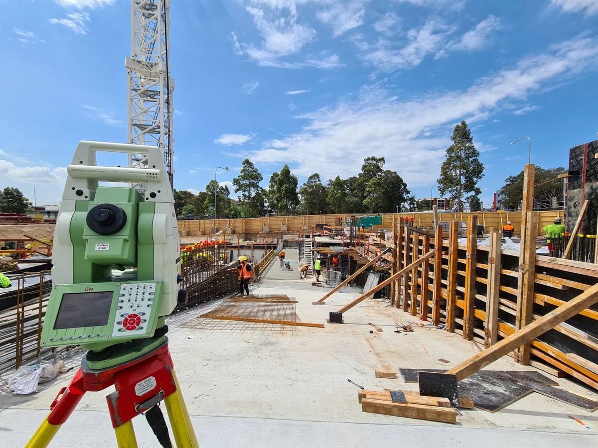 Total station set up beside formwork on a commercial construction site