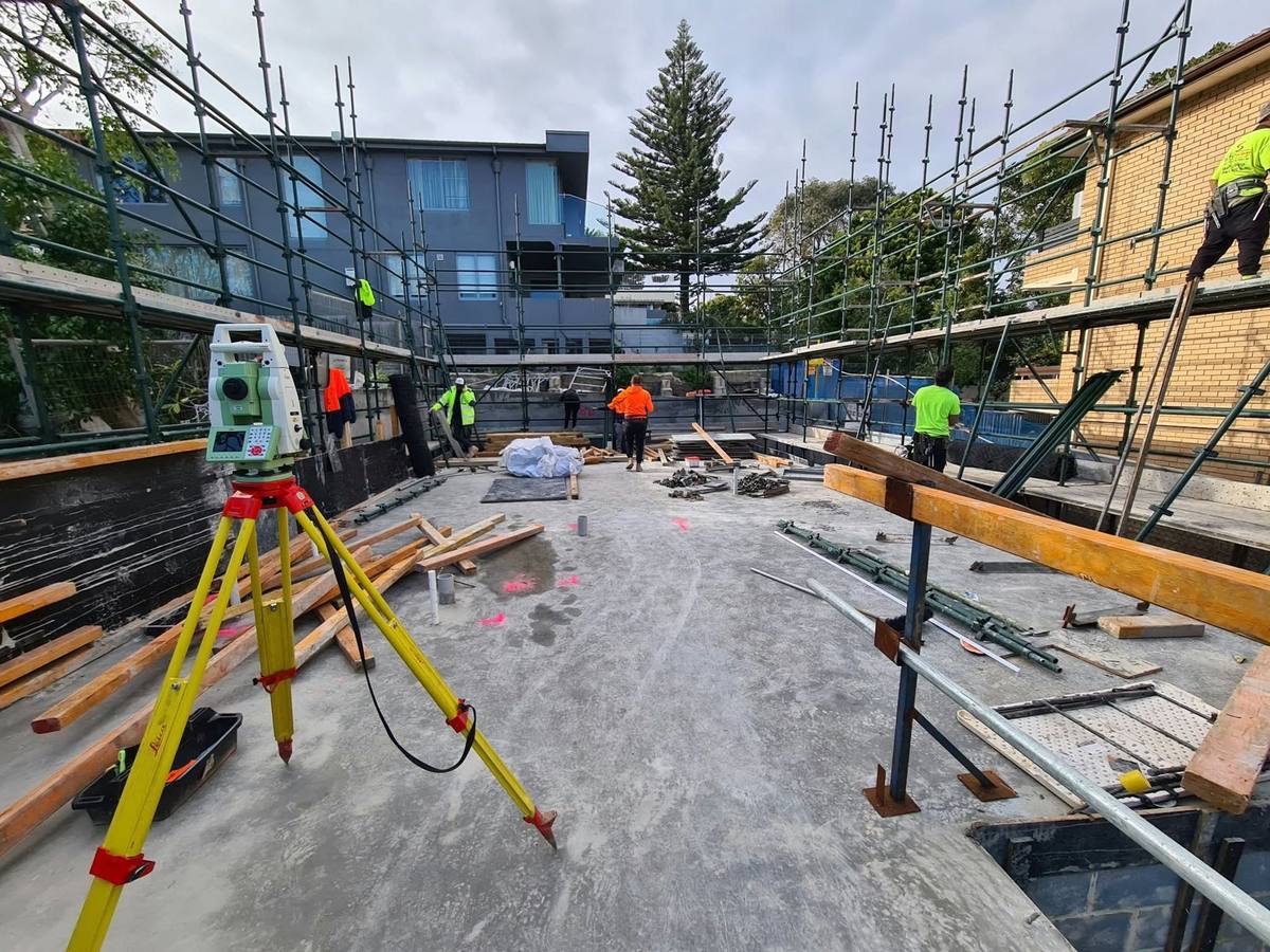 Survey setup inside a scaffolded building site
